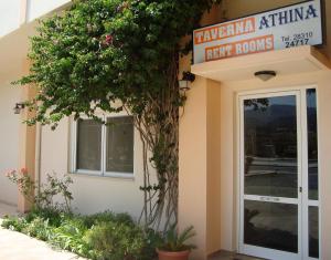 a restaurant with a sign on the side of a building at Athina in Rethymno Town