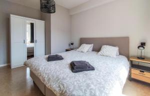 a bedroom with a bed with two towels on it at Pet Friendly Apartment In Oostende With Wifi in Ostend