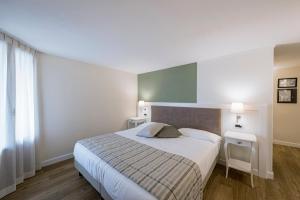 Voodi või voodid majutusasutuse Hotel Garni Corona toas