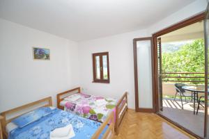 מיטה או מיטות בחדר ב-Apartments Villa Illyrik