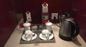 a counter with a tea pot and a tea kettle at Xinhai Jinjiang Hotel in Beijing
