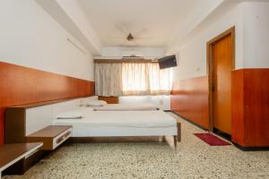 Postel nebo postele na pokoji v ubytování Hotel Srilakshmi