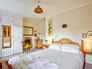 a bedroom with a large white bed with two white pillows at The Nook in Alnwick