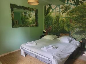 a bedroom with a large bed with a mirror at Large 14p house 35 minutes from Paris in Garancières