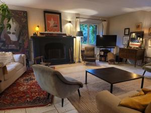 a living room with a couch and a coffee table at Large 14p house 35 minutes from Paris in Garancières