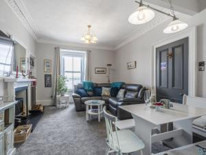 a living room with a couch and a table at Pier Haven - Cottage in Blairmore