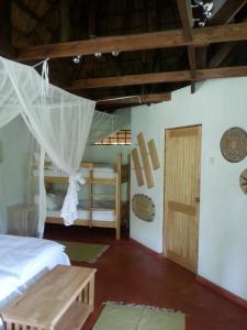 a bedroom with two beds and a door at Ng'ona Lodge in Maganga