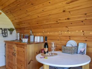 a kitchen with a table with a bottle of wine at Jacob's Den - Uk40976 in Felindre