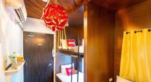 a room with a yellow curtain and a red chandelier at OYO 895 The Onion Hostel in Bangkok +159 photos