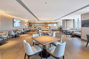 a waiting room with tables and chairs at Somerset Wanxia Shenzhen in Shenzhen