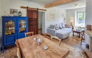 a living room with a table and a blue cabinet at 3 Bedroom Amazing Home In Plouhinec in Plouhinec