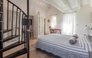 a bedroom with a bed and a staircase in it at Maison Avec Jacuzzi in Mazan