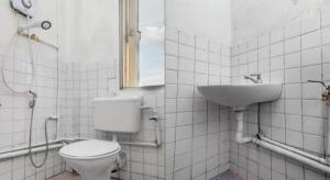a bathroom with a toilet and a sink at OYO 89706 To-day Hotel in Sibu +84 photos