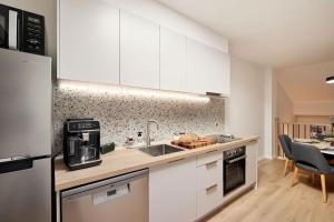 a kitchen with white cabinets and a counter top at The Brass Bear in Darlinghurst in Sydney
