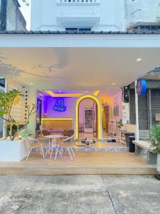a house with a table and chairs on a porch at Blue rabbit phuket in Ban Tha Khreng