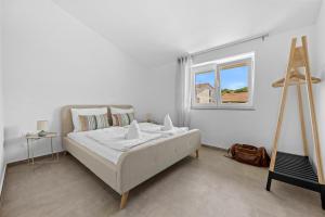 Postel nebo postele na pokoji v ubytování Apartmani Paliska