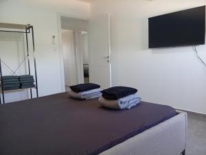 a bedroom with a bed with two pillows on it at Rest&breath in Nir Yafe
