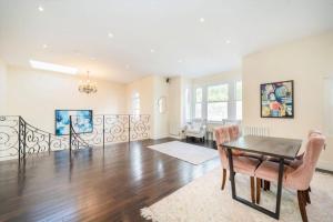 an empty living room with a table and chairs at Luxury London House in London