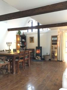 a dining room with a table and a fireplace at Old Guardhouse On West Møn in Askeby