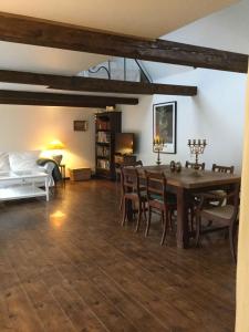 a living room with a table and chairs and a bed at Old Guardhouse On West Møn in Askeby +32 photos