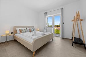 Postel nebo postele na pokoji v ubytování Apartmani Paliska