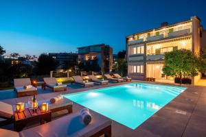 a swimming pool with lounge chairs and a building at Marevita in Podstrana