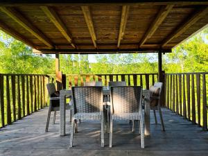a table and chairs on a wooden deck at Kızıl Kum Villa 