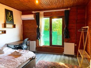 a bedroom with a bed and a window at Kızıl Kum Villa 