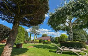 a bench sitting in the grass in a park at Awesome Home In Cieciorka in Cieciorka +18 photos