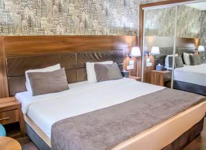 Postel nebo postele na pokoji v ubytování Ma City Hotel