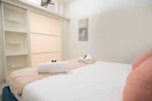 a white bed with two white towels on top of it at Pantheon Luxury Apartment in Rome