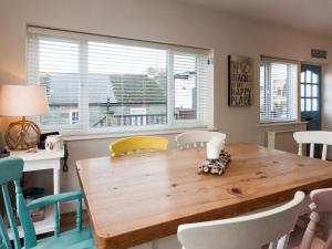 Un comedor con mesa y sillas de madera. en Aloft, en Salcombe