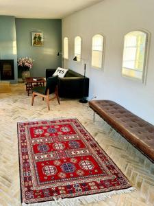 a living room with a couch and a rug at Historic Laundry House By Gentofte Lake in Gentofte