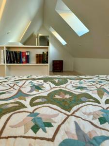 a bedroom with a bed with a design on it at Historic Laundry House By Gentofte Lake in Gentofte