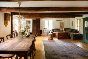 a living room with a table and a couch at The Hallandsåsen Lighthouse, A Natural Retreat in Munka-Ljungby +12 photos