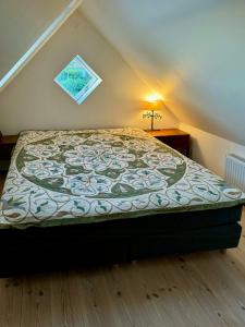 a bedroom with a large bed in a attic at Historic Laundry House By Gentofte Lake in Gentofte
