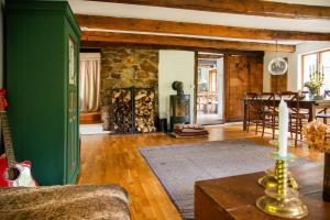 a living room with a green wall and a fireplace at The Hallandsåsen Lighthouse, A Natural Retreat in Munka-Ljungby