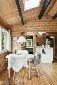 a kitchen and dining room with a table and chairs at Simple Life In Traditional Home By Lyngså Beach in Sæby