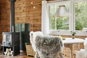 a living room with a table and a stove at Simple Life In Traditional Home By Lyngså Beach in Sæby