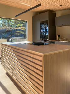 a kitchen with a large island in the middle at Modern Beach House At Røssesund Tjøme in Tjøme