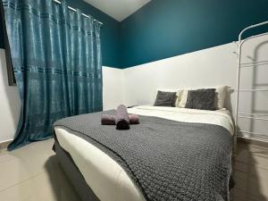 a bedroom with a bed with a teddy bear on it at Brand New Cozy Home Desaru Coast Near to SKS waterpark hard rock in Bandar Penawar