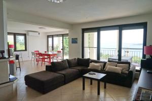 a living room with a couch and a table at Six bedroom luxury villa with private pool in quiet residential area near beaches in Sozopol