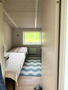 a small room with two beds and a window at Family Retreat By Roskilde Fjord in Ølsted +16 photos