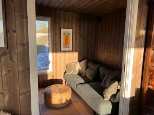 a living room with a couch in a house at Traditional Cabin In Modern Drøbak in Drøbak