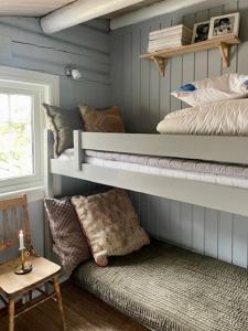 a room with two bunk beds and a bench at Log Cabin With Views Of Rondane Mountains in Folldal