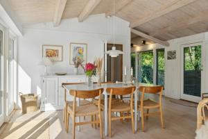 a dining room with a table and chairs at Holiday Home On Hilltop By Sejerø Bay in Nykøbing Sjælland