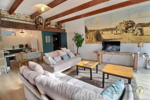 a living room with a couch and a table at La grange in Penvénan