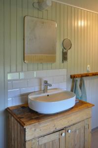 a bathroom with a sink and a mirror on a counter at Turn-Of-The-Century House Near Lake Vikarn in Matfors +28 photos