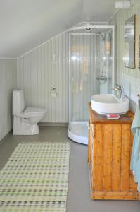 a bathroom with a sink and a toilet and a shower at Turn-Of-The-Century House Near Lake Vikarn in Matfors