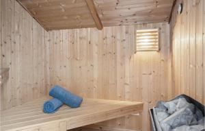 a wooden sauna with a blue towel on a shelf at Cassiopeia in Sjølund